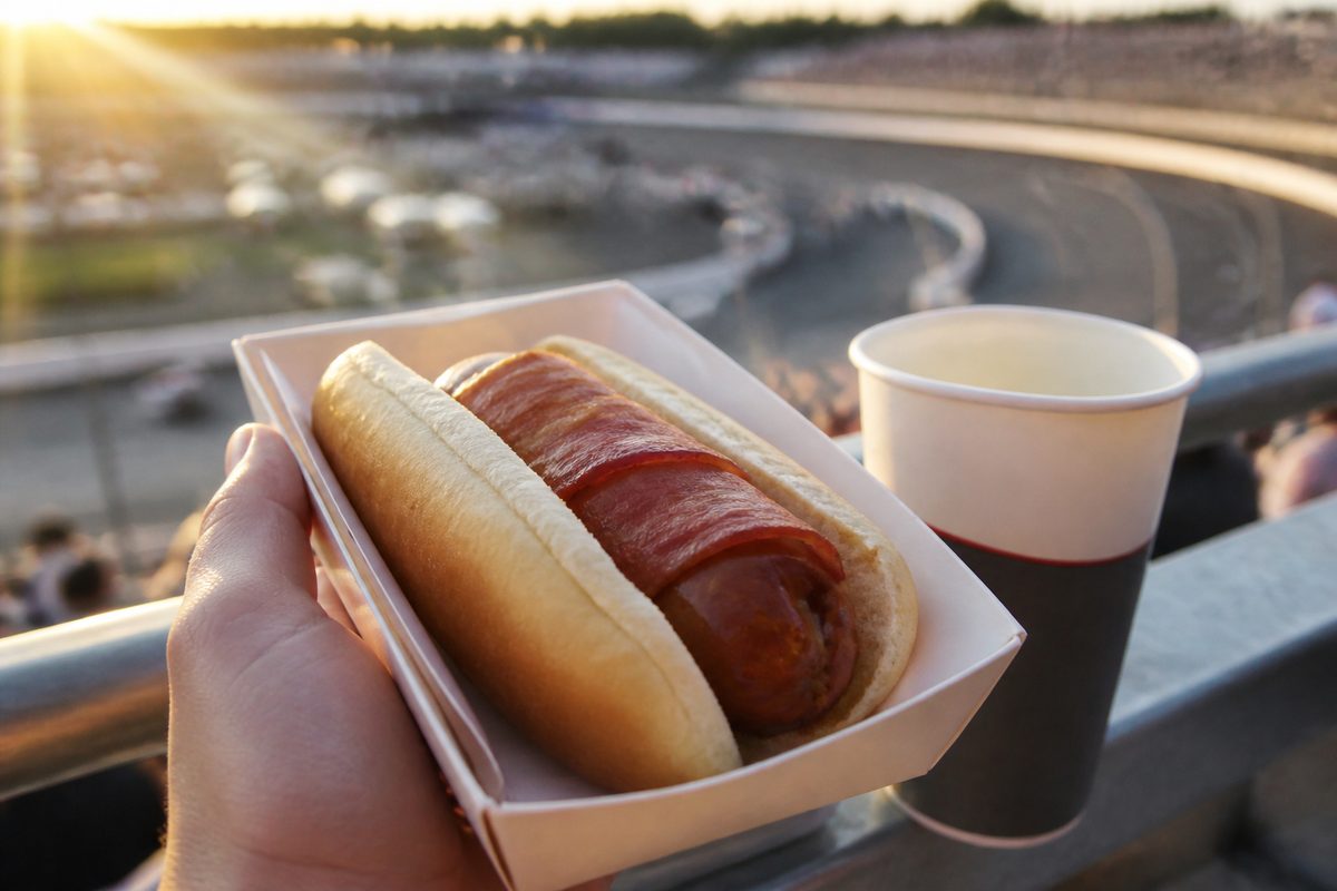 POV of a bacon wrapped hot dog at sunset