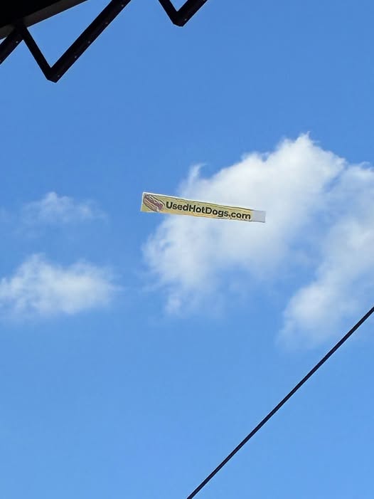 UsedHotDogs.com banner in the sky