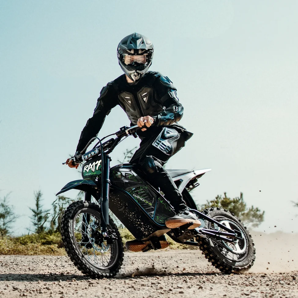 Rider demonstrating the black and green electric dirt bike giveaway prize